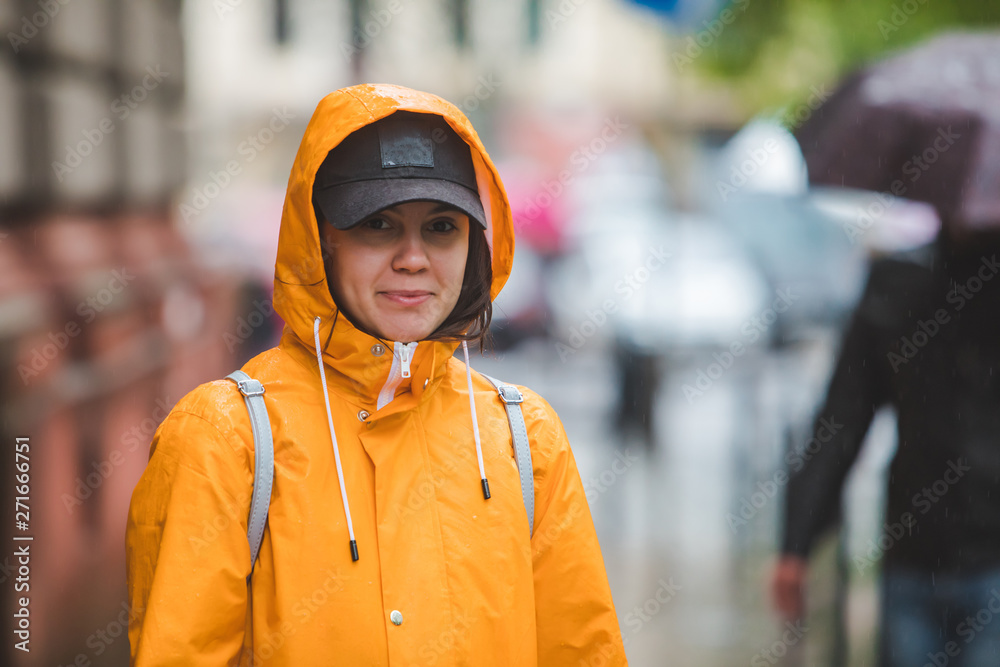 portrait of smiling woman in yellow raincoat portrait of smiling woman in yellow raincoat