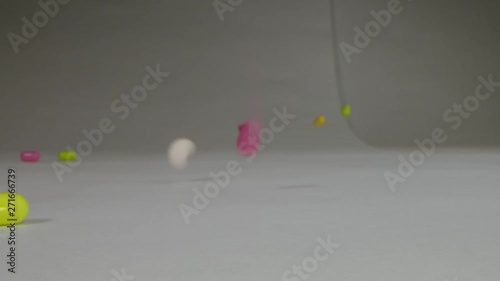 Pills falling on table in slow motion macro using the Laowa macro lens. photo