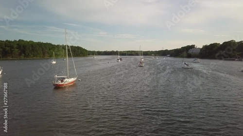 Slow flight over Greenwich Cove, Rhode Island with moored yachts in calm safe haven photo