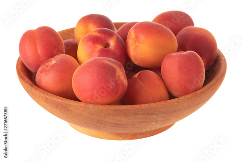 heap of red apricots in wooden cup isolated on white background