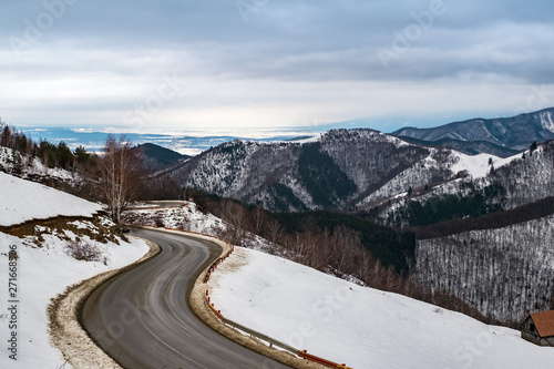 road coming through the winter mountains, Paltinis area, Sibiu county, Cindrel Mountains, Romania