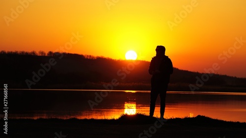 silhouette of fisherman at sunset