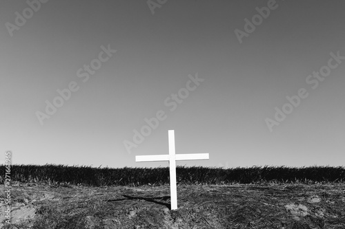 A cross on a hillside, a grave site in open country,Field photo