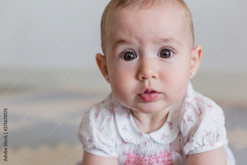 portrait of a beautiful baby girl at home. Family concept indoors. Daytime and lifestyle portrait of a beautiful baby girl at home. Family concept indoors. Daytime and lifestyle