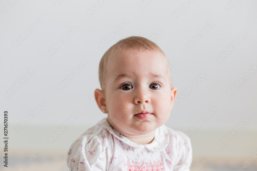 portrait of a beautiful baby girl at home. Family concept indoors. Daytime and lifestyle portrait of a beautiful baby girl at home. Family concept indoors. Daytime and lifestyle