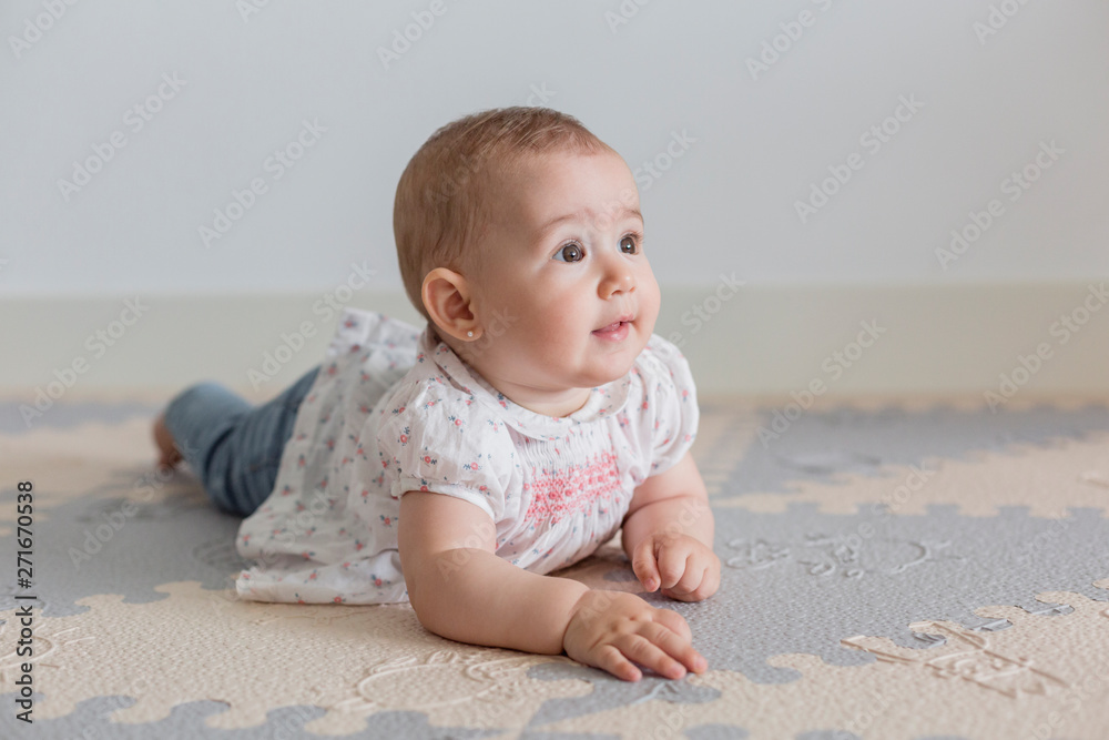 portrait of a beautiful baby girl at home. Family concept indoors. Daytime and lifestyle portrait of a beautiful baby girl at home. Family concept indoors. Daytime and lifestyle