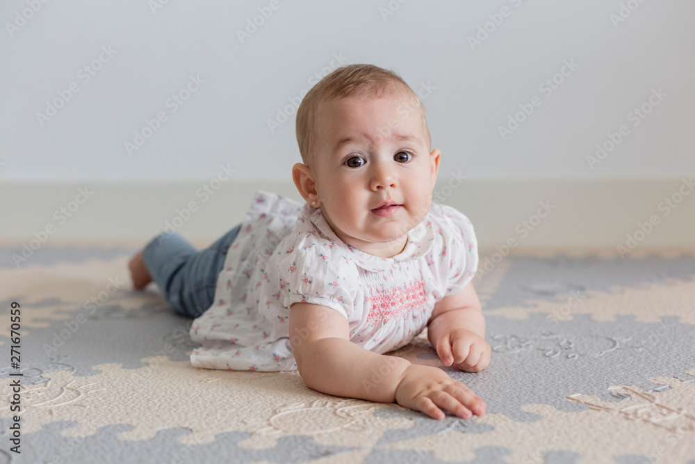 portrait of a beautiful baby girl at home. Family concept indoors. Daytime and lifestyle portrait of a beautiful baby girl at home. Family concept indoors. Daytime and lifestyle