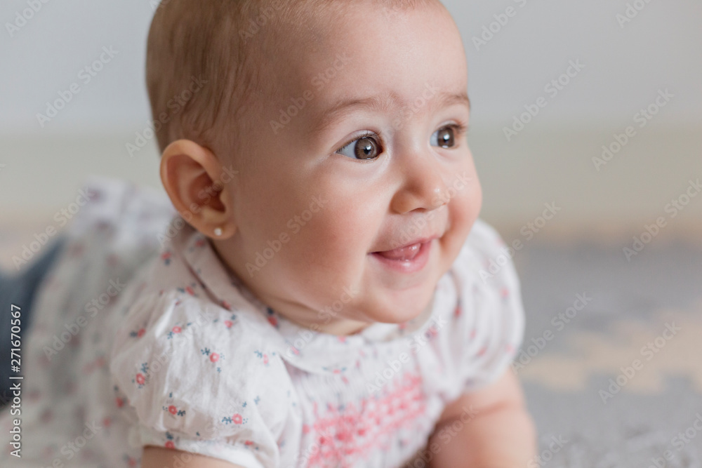 portrait of a beautiful baby girl at home. Family concept indoors. Daytime and lifestyle portrait of a beautiful baby girl at home. Family concept indoors. Daytime and lifestyle