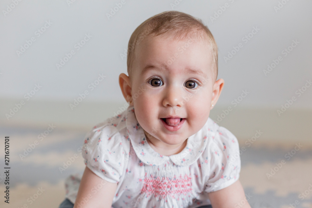 portrait of a beautiful baby girl at home. Family concept indoors. Daytime and lifestyle portrait of a beautiful baby girl at home. Family concept indoors. Daytime and lifestyle