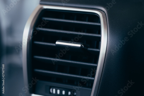 Car conditioner. The air flow inside the car. Detail interior. Air ducts, deflectors on the car panel © Nana_studio