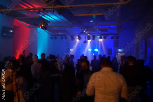 DJ party in a club with crowd, partypeople and lightshow.