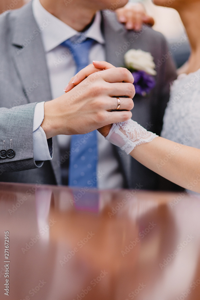 bride and groom holding their hands