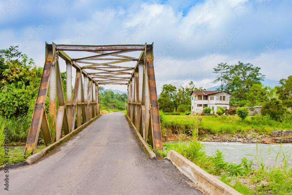 Montanita. Ecuador. Montanita village. Streets of Montanita. River bridge in Ecuador. Ancient bridge. Old metal bridge across the river.