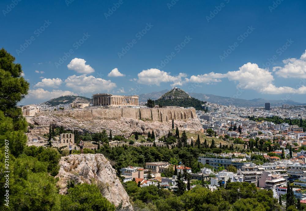 Acropolis and Lycabettus Hill framed by trees from the summit of Lycabettus hill