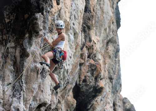 Thailand, Krabi, Chong Pli, woman climbing in rock wall photo