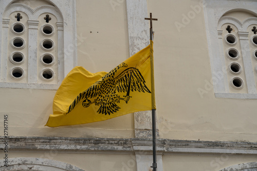 Double-headed flag on St George Orthodox church in old town in the city of Nafplio in Greece photo