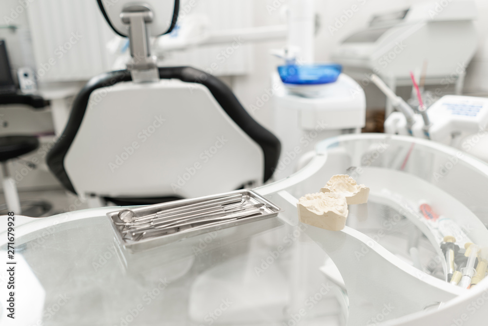 Stomatological tools in the dentists clinic. Dental work in clinic. Operation, tooth replacement. Medicine, health, stomatology concept. Office where dentist conducts inspection and concludes. Stomatological tools in the dentists clinic. Dental work in clinic. Operation, tooth replacement. Medicine, health, stomatology concept. Office where dentist conducts inspection and concludes.