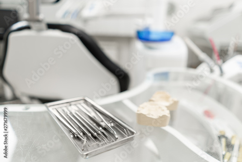 Stomatological tools in the dentists clinic. Dental work in clinic. Operation, tooth replacement. Medicine, health, stomatology concept. Office where dentist conducts inspection and concludes.