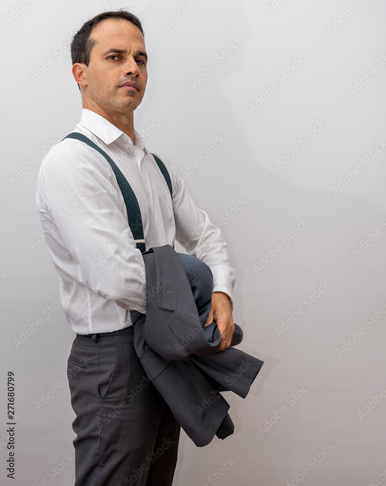 Stylish young man in formal suit posing isolated on grey Stock Photo - Alamy