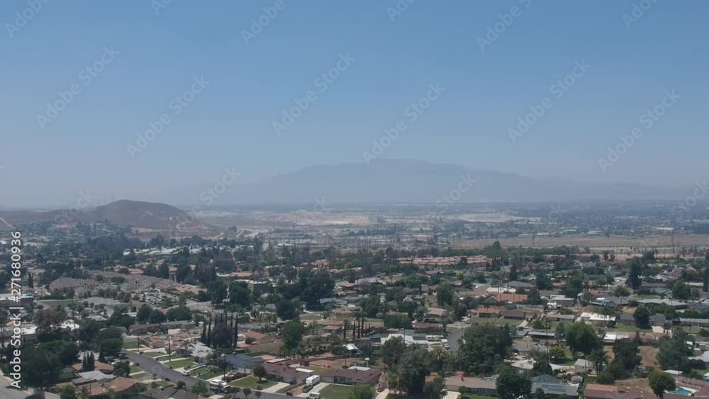 Aerial view of suburban neighborhood and mountain in daylight. Aerial view of suburban neighborhood and mountain in daylight.