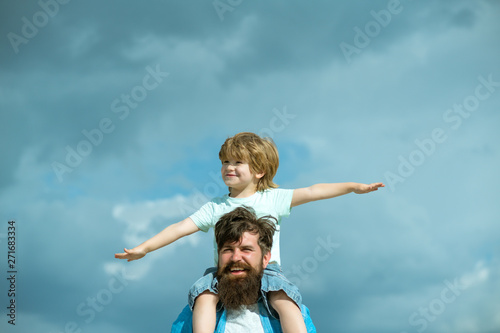 Father and son playing together. Child sits on the shoulders of his father. Family Time.