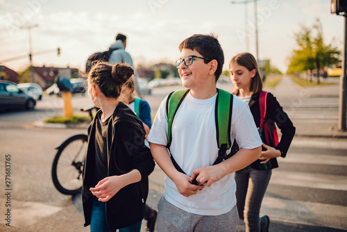 Group of school children crossing road