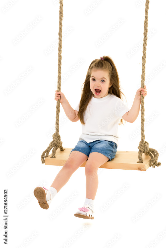 Little girl swinging on a swing