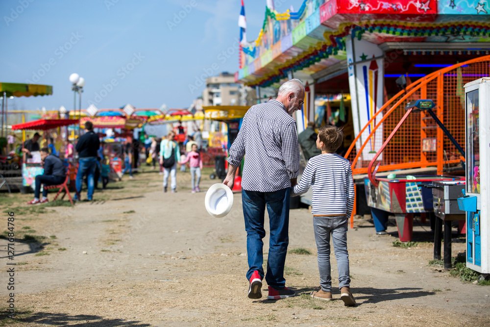 Grandfather and grandson amusement park fun