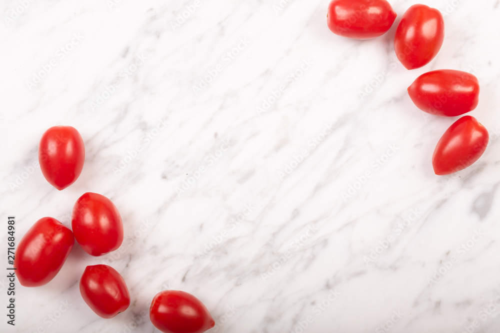 Cherry tomatoes on a white marble background with copy space Cherry tomatoes on a white marble background with copy space