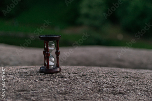 Hourglass on a stone in the dark.