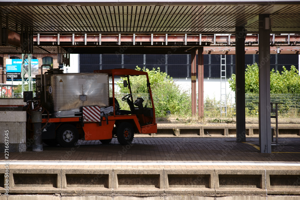Ein Gepäckwagen und Arbeitsfahrzeug zum Werkzeugtransport und Materialtransport an einem Bahnsteig.