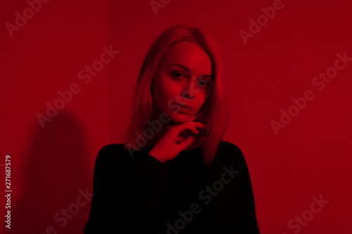 young teen girl in red blue purple light