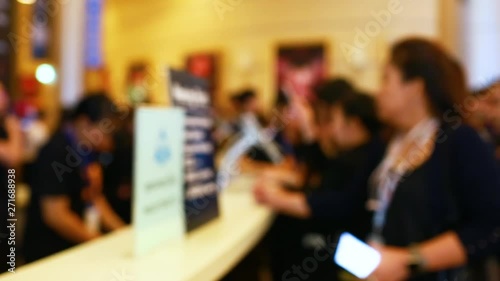 Many business people attending the seminar are scanning QR Code  for registration with smart phone and tablat.   Blurry Video for background.