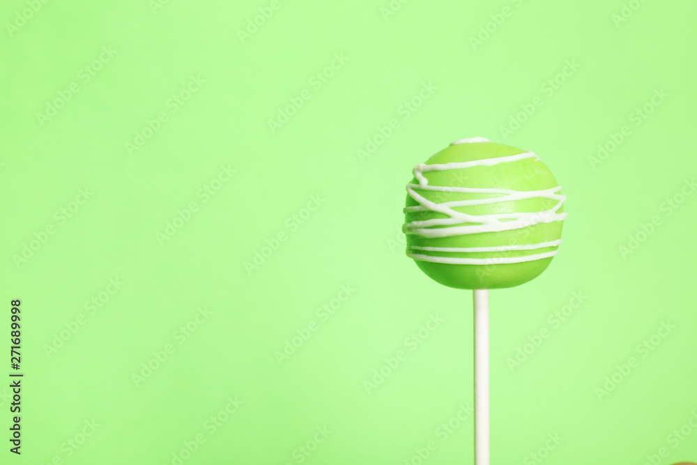 Bright delicious cake pop on color background. Space for text