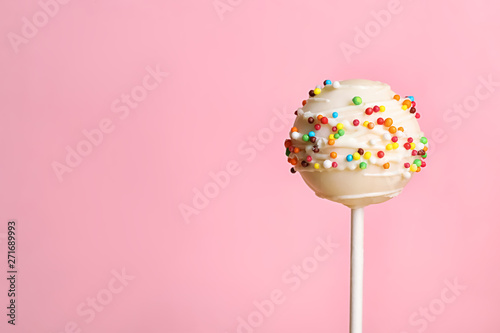 Foto Bright delicious cake pop on color background. Space for text