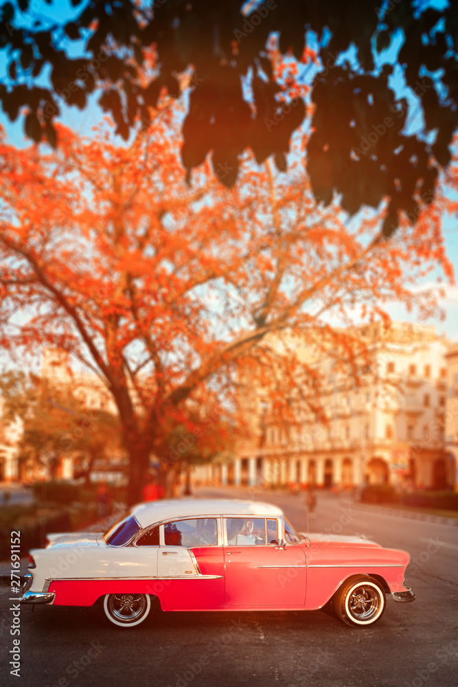 Pink classic car at sunset in Havana