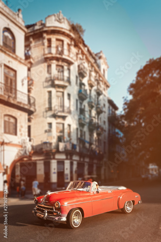 Pink classic car and old buildings in downtown Havana © kmiragaya