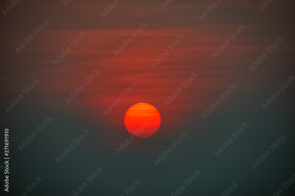 Sun at Sunset in Haze and Clouds Sun at Sunset in Haze and Clouds