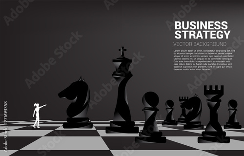 Silhouette of businesswoman point forward with chess piece. concept of business strategy marketing.