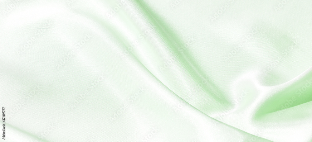 The texture of the satin fabric of green color for the background