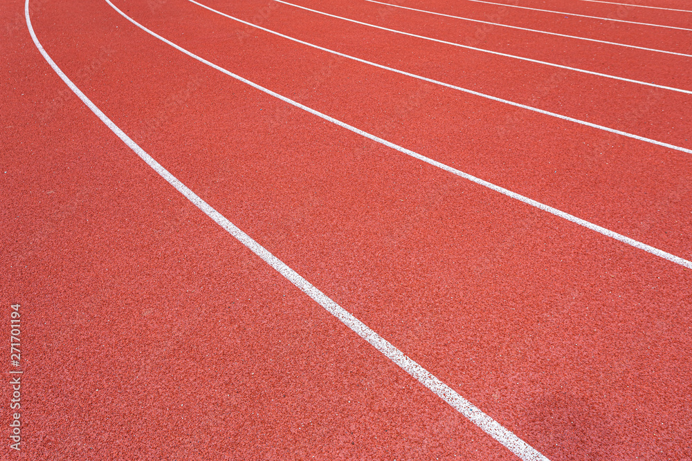 White lines of stadium and texture of running racetrack red rubber racetracks in outdoor stadium are 8 track and green grass field,empty athletics stadium with track.