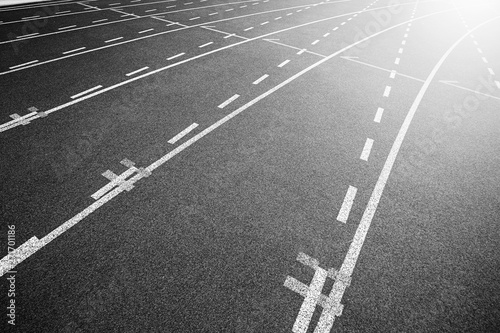 White lines of stadium and texture of running racetrack black rubber racetracks in outdoor stadium are 8 track and green grass field,empty athletics stadium with track.