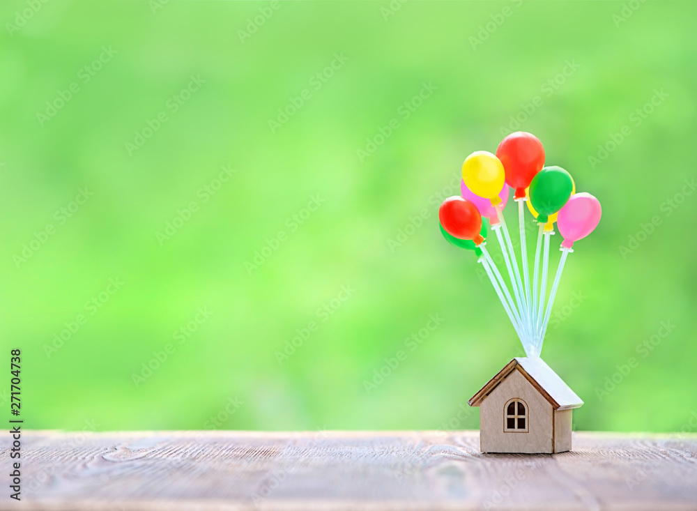 Air balloons and house on green nature background. Home model hanging on  colorful balloons. plan real estate, Business investment or loan for real  estate concept. copy space. Stock Photo | Adobe Stock