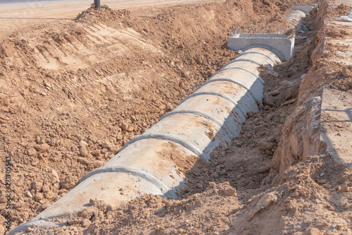 Concrete Drainage Pipe on a Construction Site, Concrete drainage tank on construction site, construction site at the road