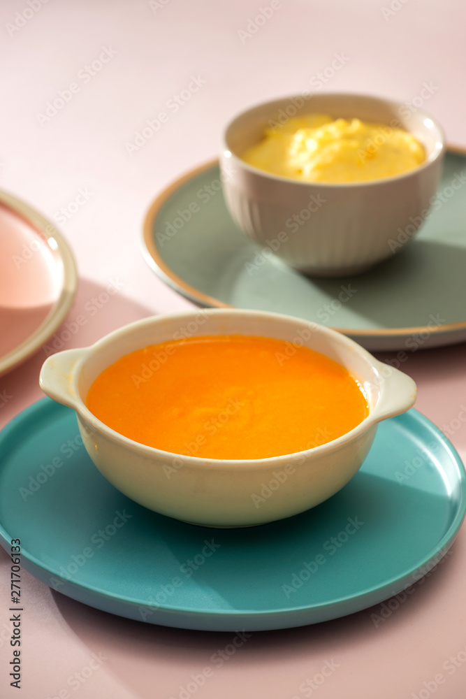 Carrot baby puree in bowl isolated on light background Carrot baby puree in bowl isolated on light background