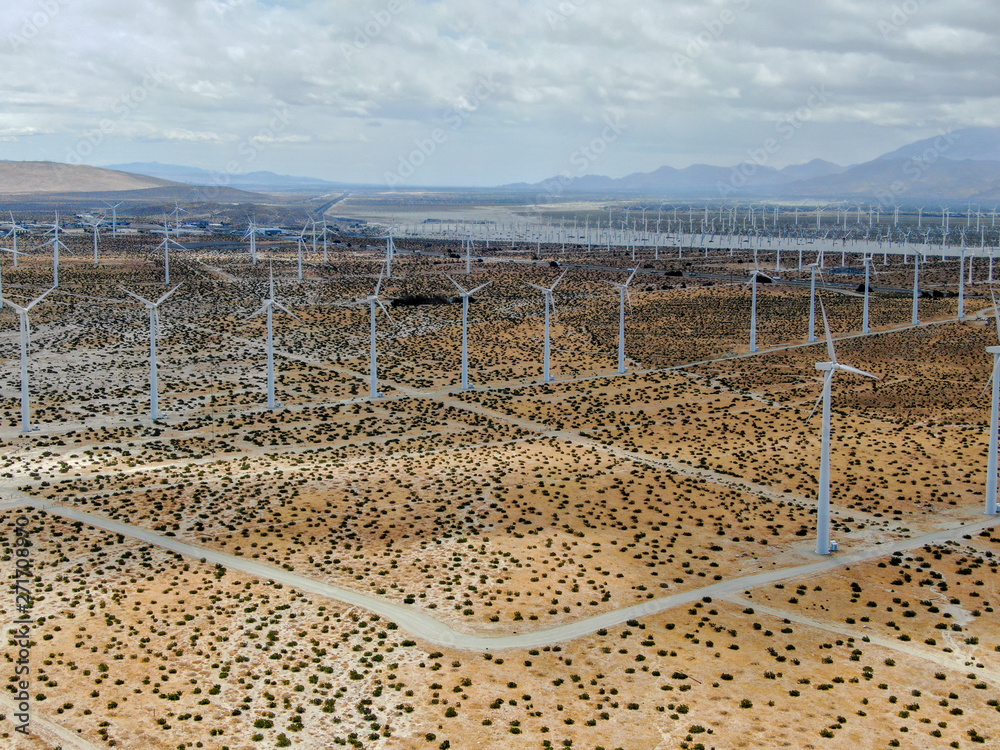 Aerial view of wind turbines generating electricity. Huge array of gigantic wind turbines spreading over the desert in Palm Springs wind farm, California, USA 