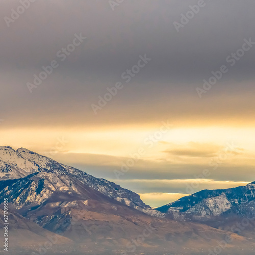 Square Panorama of a majestic mountain covered with snow and illuminated by sunlight