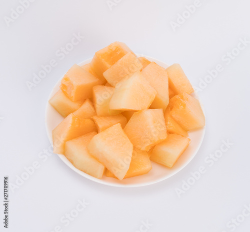 cantaloupe malons slices on white plate 