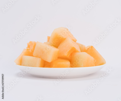 cantaloupe malons slices on white plate 