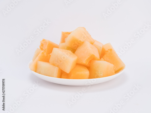 cantaloupe malons slices on white plate 